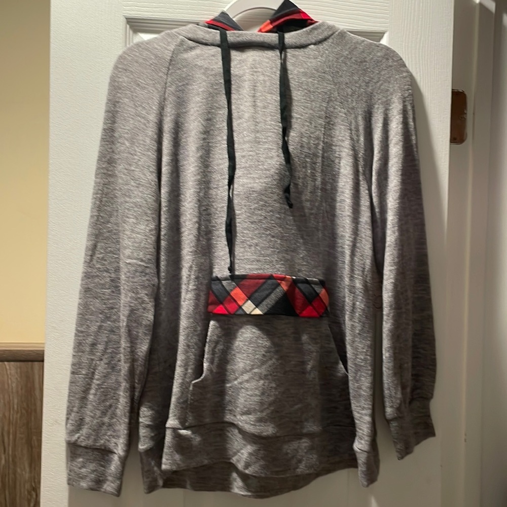 Main strip light sweatshirt. Grey and plaid hood and pocket.